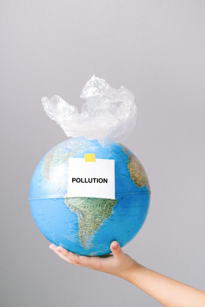 Earth globe wrapped in plastic bag symbolizing pollution and environmental impact.